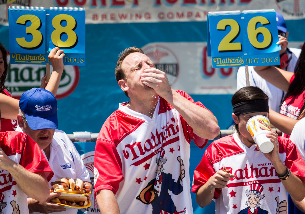 Why it is now a contest to eat hot dogs, a Fourth of July tradition for many Americans